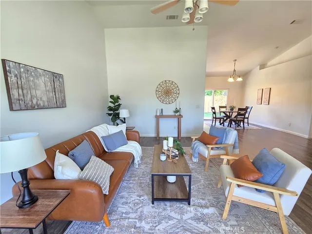 a living room with furniture a rug and a chandelier