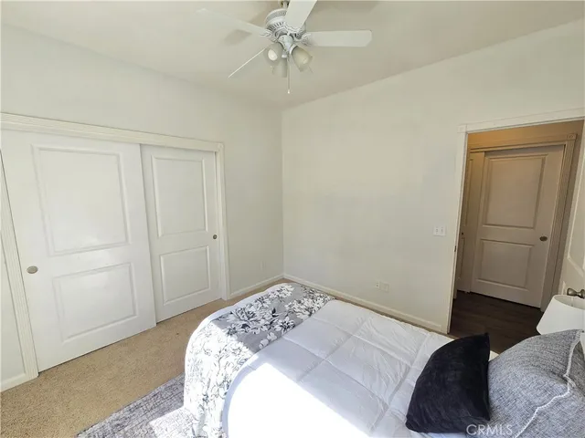a bedroom with a bed and cabinets