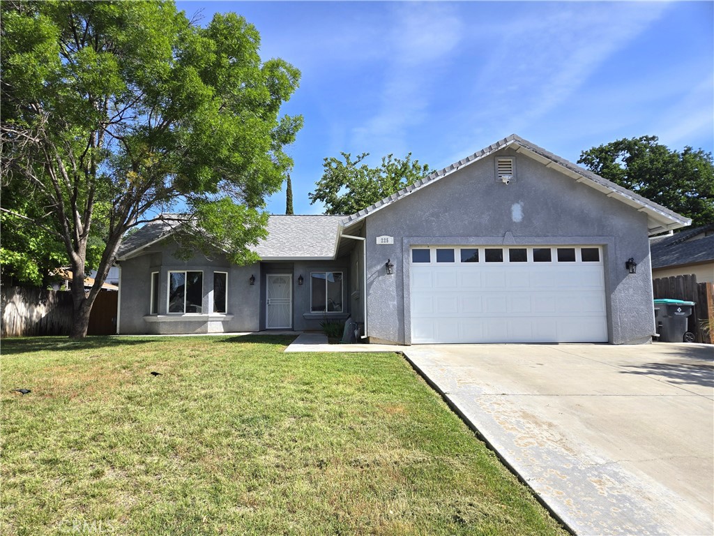 225 Sparrow Court Red Bluff, CA 96080 - Photo 29 of 29 a front view of a house with a yard and garage
