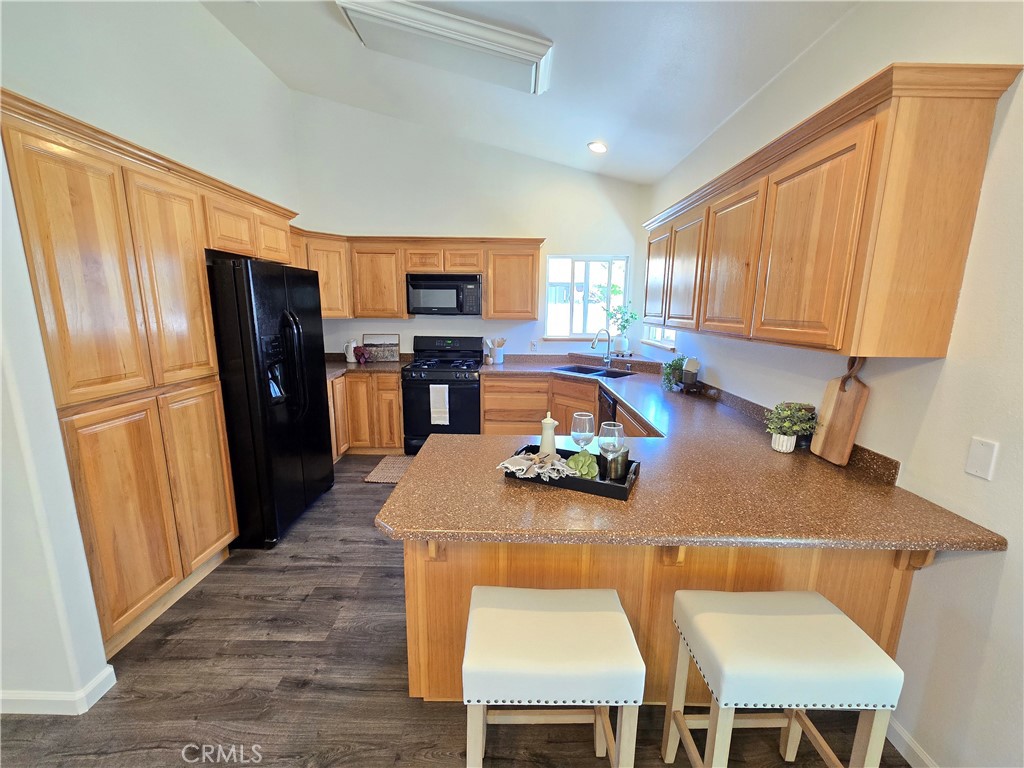 225 Sparrow Court Red Bluff, CA 96080 - Photo 5 of 29 a kitchen with a table chairs refrigerator and a window