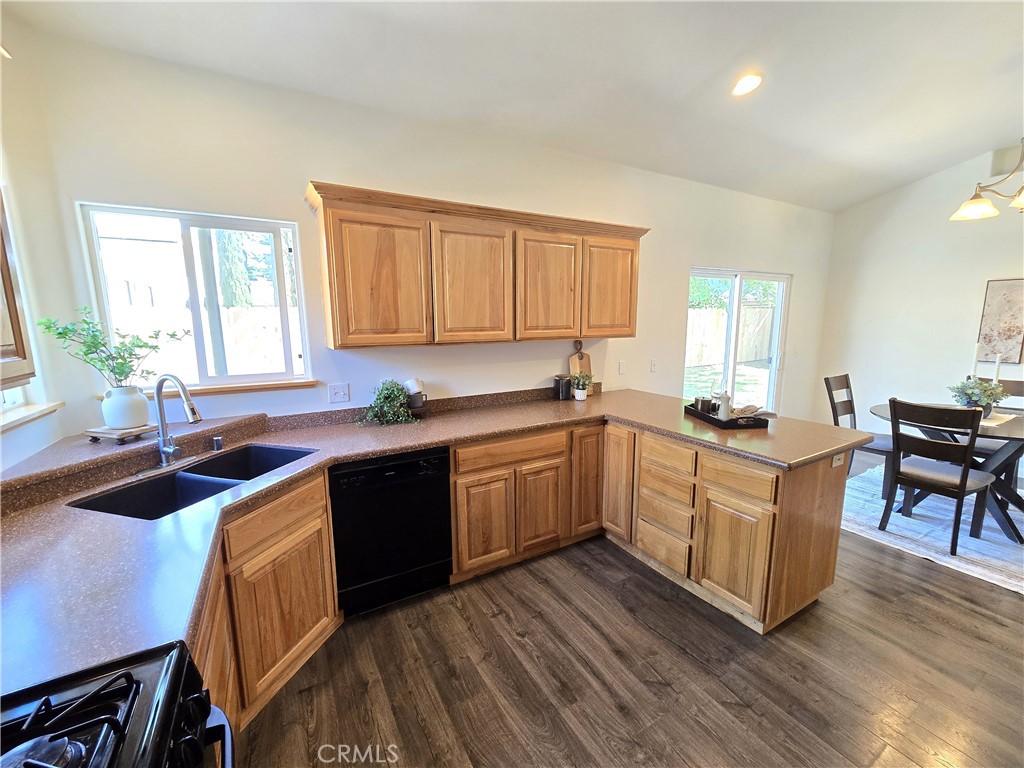 225 Sparrow Court Red Bluff, CA 96080 - Photo 6 of 29 a kitchen with granite countertop a sink a counter top space and cabinets