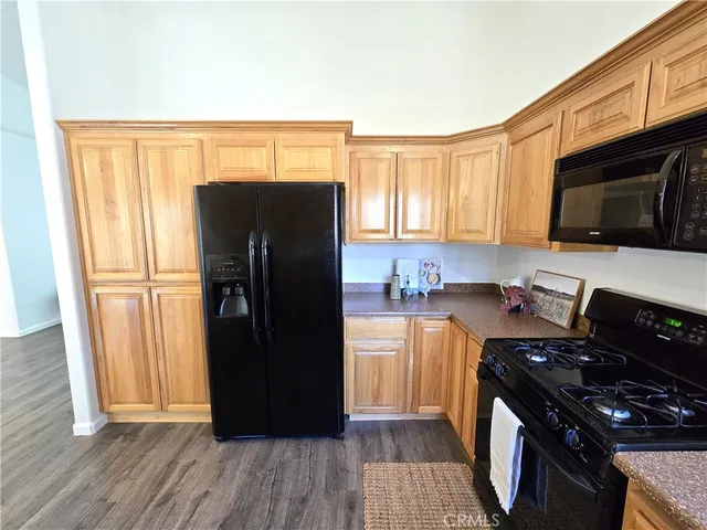 a kitchen with a refrigerator stove and wooden cabinets