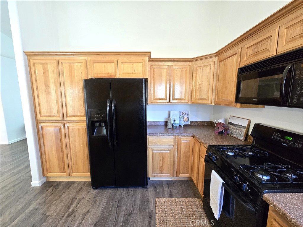 225 Sparrow Court Red Bluff, CA 96080 - Photo 7 of 29 a kitchen with a refrigerator stove and wooden cabinets