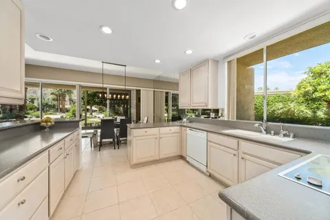 a kitchen with counter top space and outdoor view