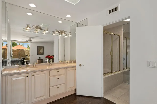 a bathroom with a double vanity sink and mirror
