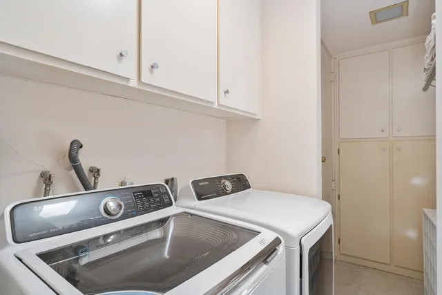 a view of a patio with a table and chairs under an umbrella