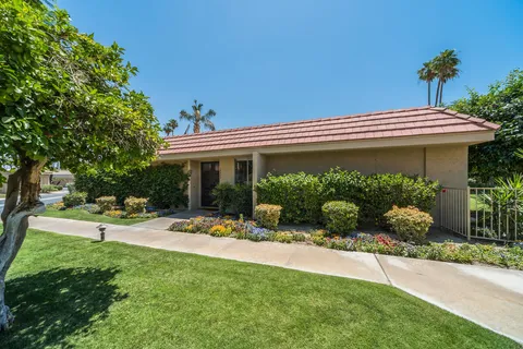 a front view of a house with potted plants