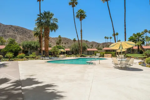 a view of swimming pool with outdoor seating and plants