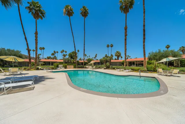 a view of a swimming pool with a table and chairs
