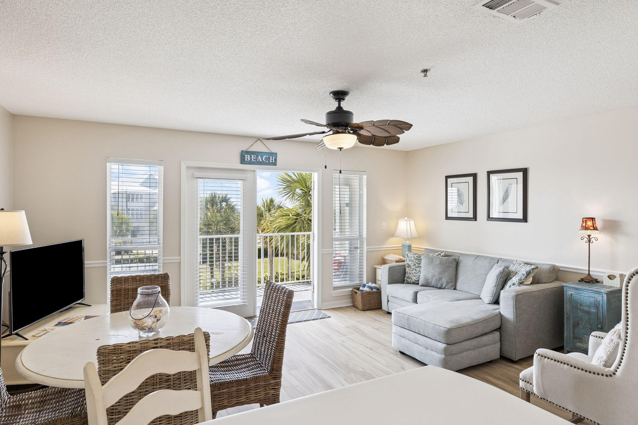 144 Spires Lane, Unit 310 Santa Rosa Beach, FL 32459 - Photo 13 of 41 a living room with furniture a flat screen tv and a large window