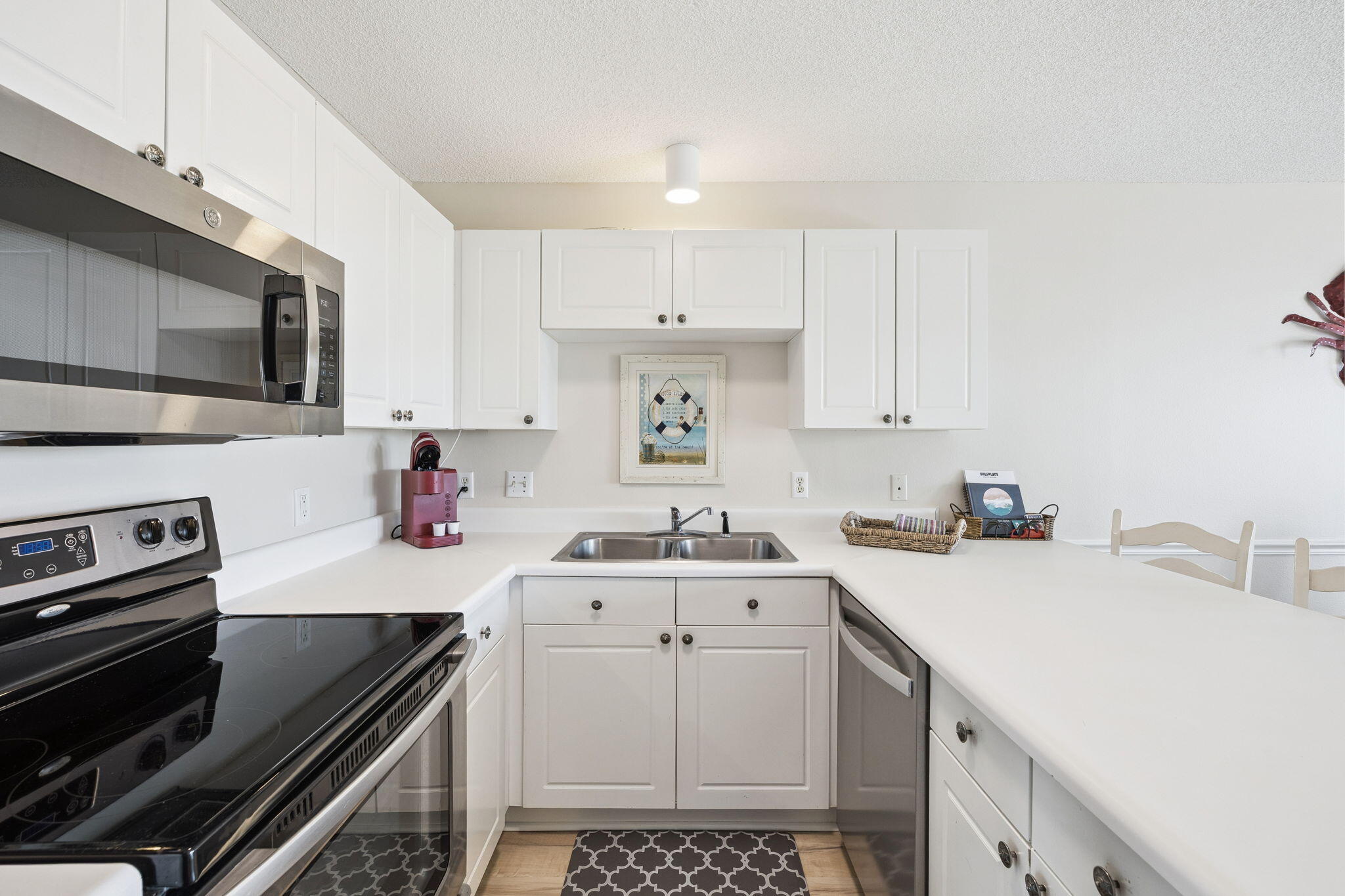 144 Spires Lane, Unit 310 Santa Rosa Beach, FL 32459 - Photo 16 of 41 a kitchen with a sink a stove and cabinets