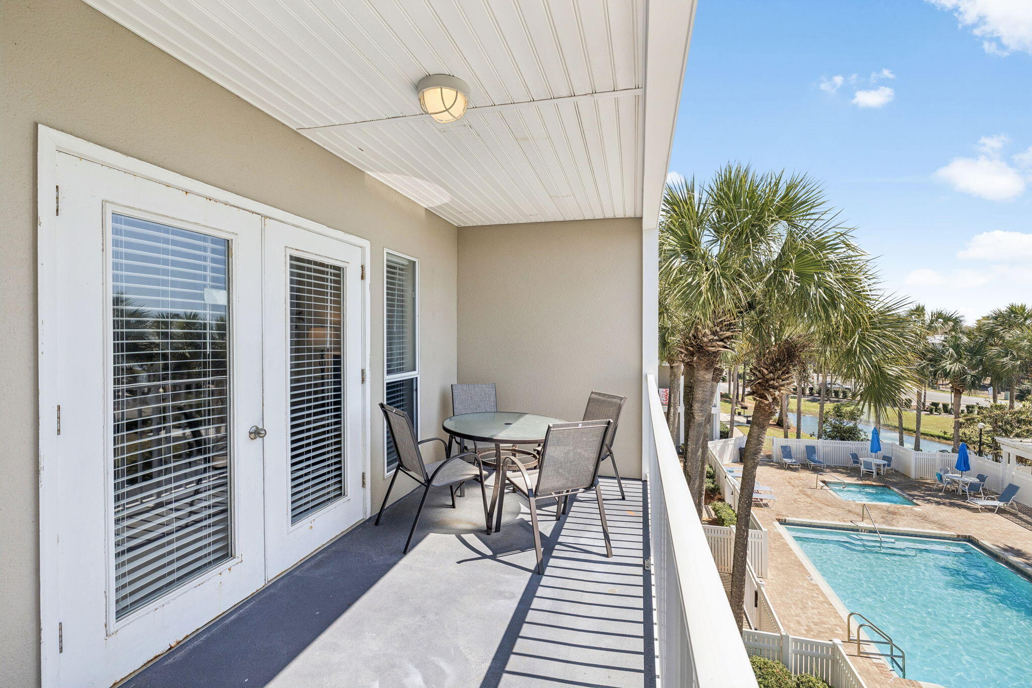 144 Spires Lane, Unit 310 Santa Rosa Beach, FL 32459 - Photo 30 of 41 a view of a patio with table and chairs with wooden floor and fence