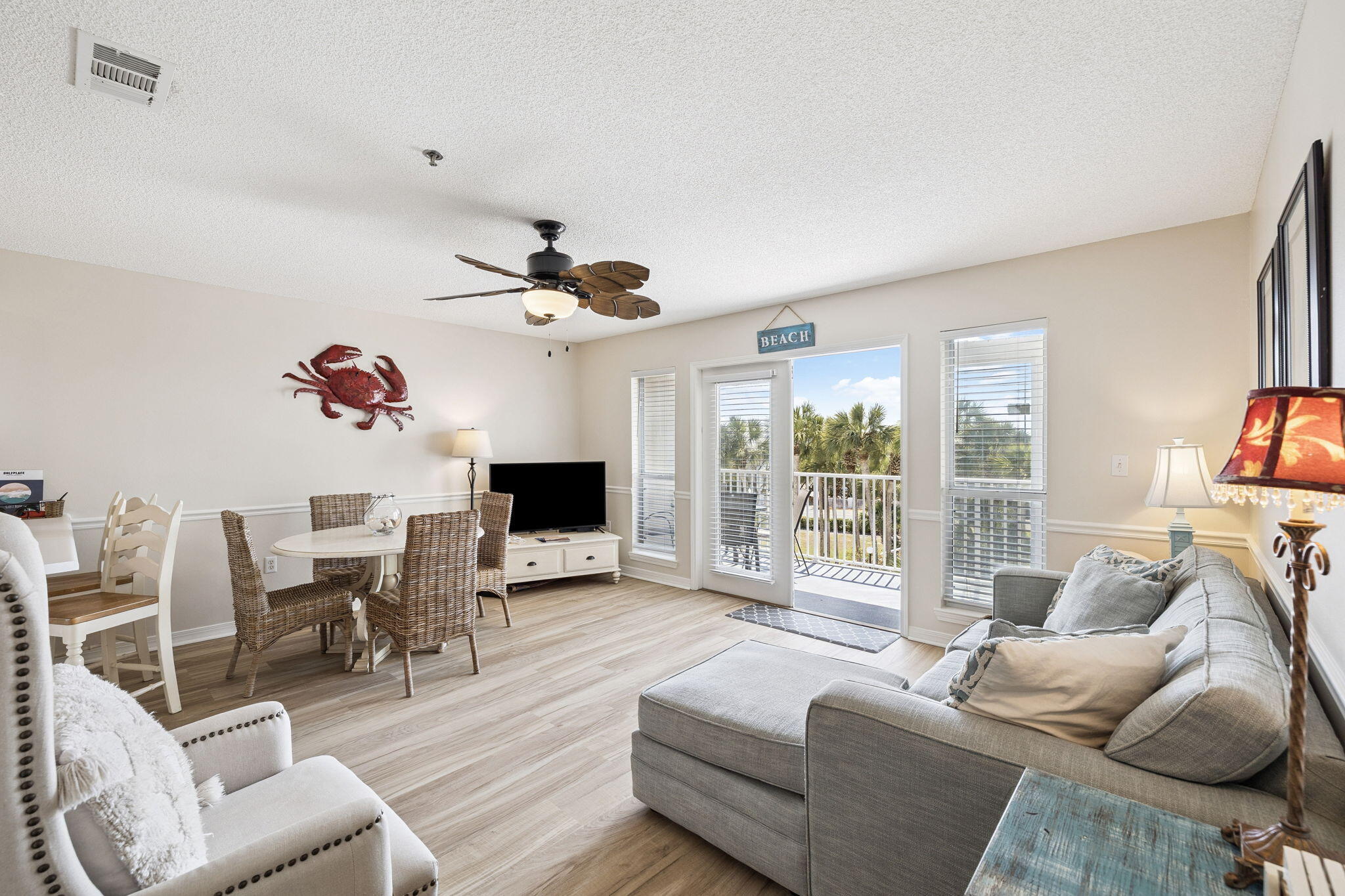144 Spires Lane, Unit 310 Santa Rosa Beach, FL 32459 - Photo 10 of 41 a living room with furniture a flat screen tv and a large window