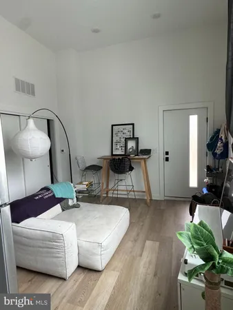 a living room with furniture and a mirror