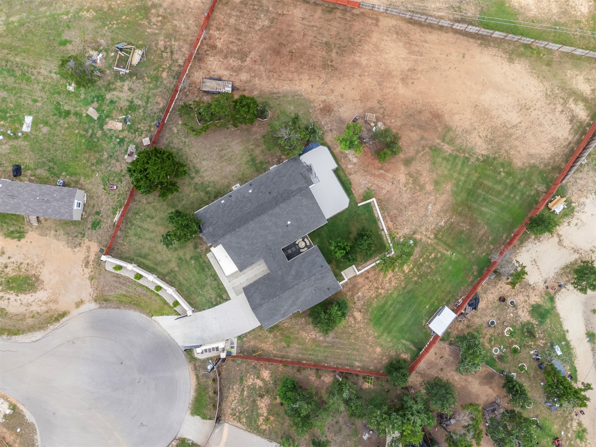 123 Zacate Street Elgin, TX 78621 - Photo 28 of 33 Single-story residence featuring a dark shingle roof and an attached concrete driveway
