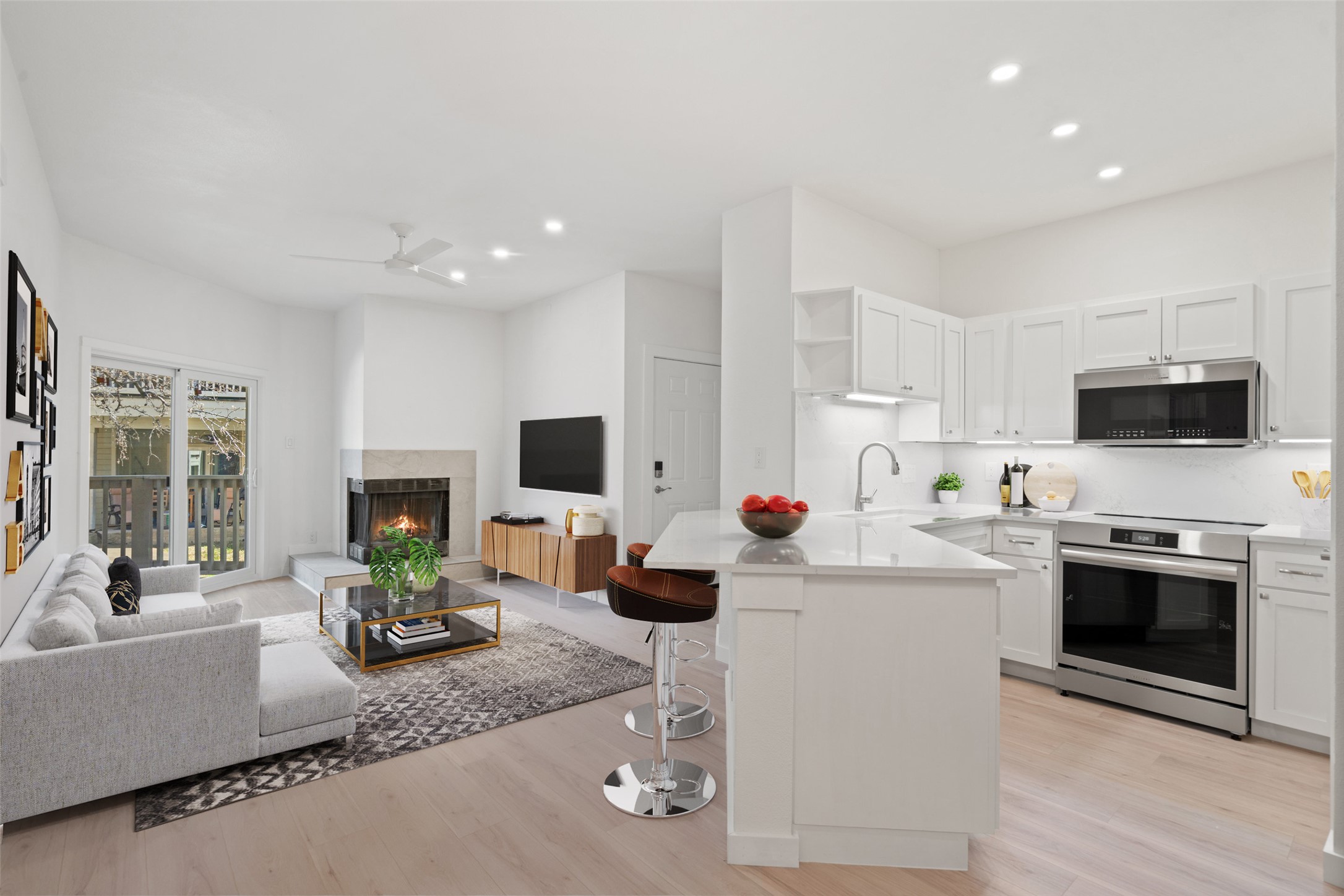 a kitchen with stainless steel appliances kitchen island granite countertop a sink and a stove top oven with wooden floor