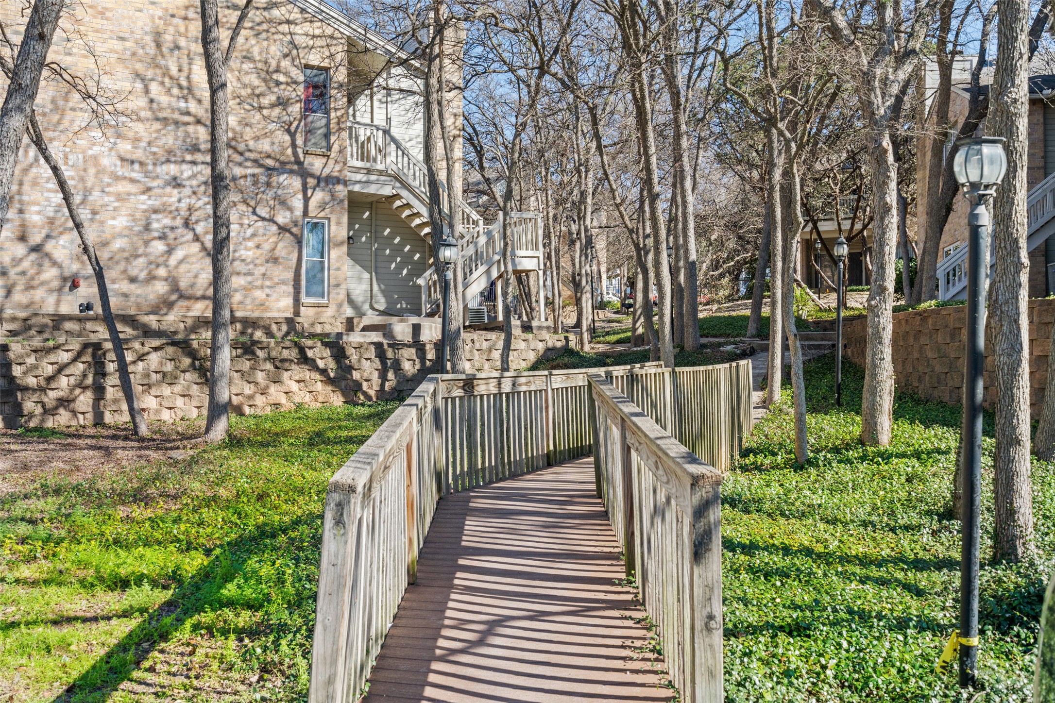 2450 Wickersham Lane, Unit 1307 Austin, TX 78741 - Photo 16 of 20 Surrounding community featuring stairway and fence