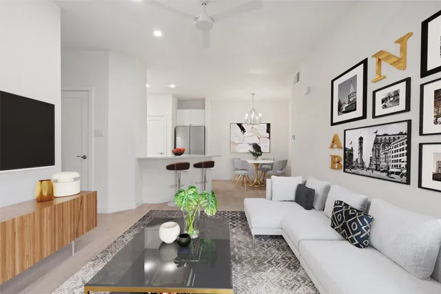 a living room with furniture flowerpot and wooden floor