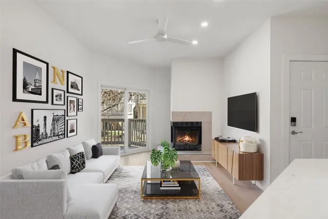 a living room with furniture a fireplace and a flat screen tv