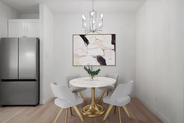 a view of a dining room with furniture wooden floor and a chandelier