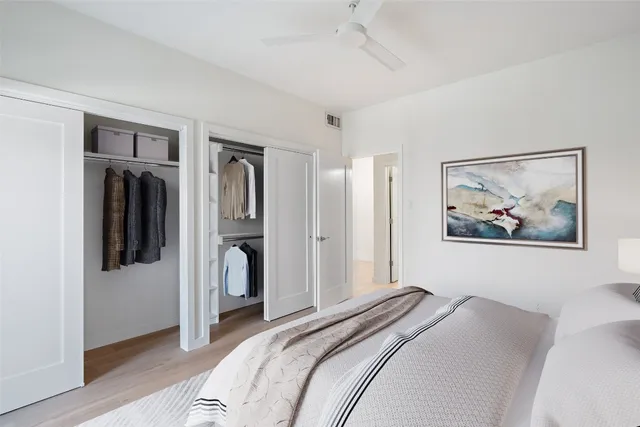 a bedroom with a bed and a painting on the wall