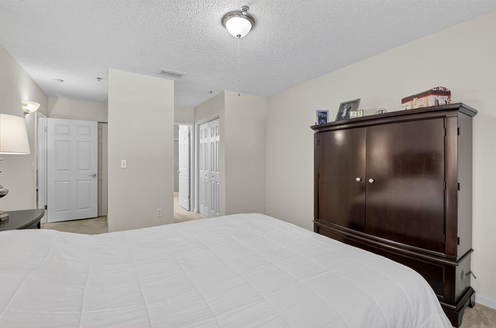 3237 Clint Moore Road, Unit 206 Boca Raton, FL 33496 - Photo 15 of 49 a bedroom with a bed and a mirror