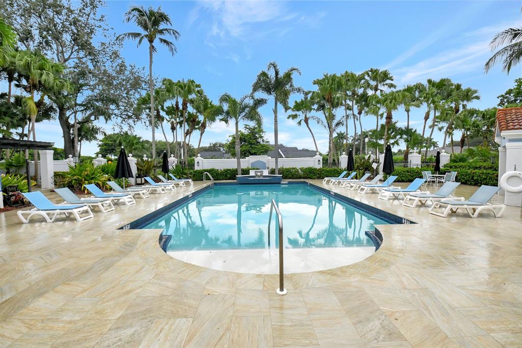 3237 Clint Moore Road, Unit 206 Boca Raton, FL 33496 - Photo 32 of 49 a view of a swimming pool with a patio