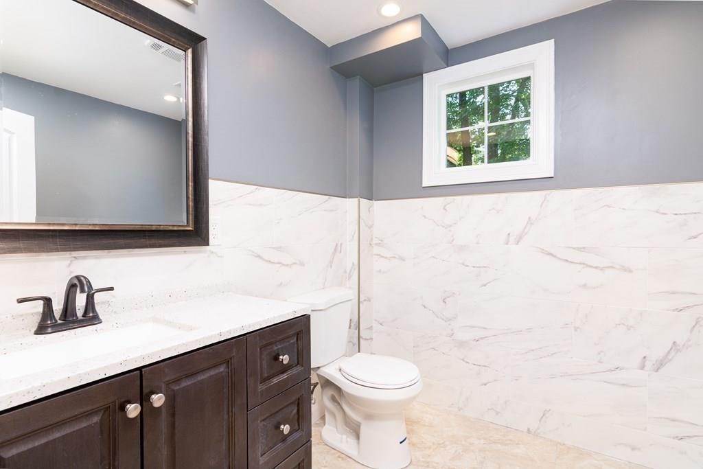23 Amelian Road Randolph, MA 02368 - Photo 16 of 39 a bathroom with a toilet sink and mirror
