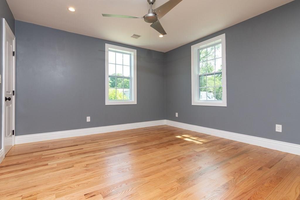 23 Amelian Road Randolph, MA 02368 - Photo 23 of 39 a view of an empty room with a window and wooden floor