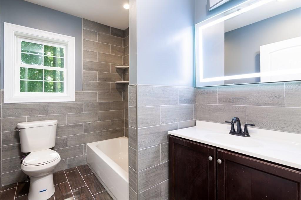 23 Amelian Road Randolph, MA 02368 - Photo 26 of 39 a bathroom with a sink a toilet and a bathtub