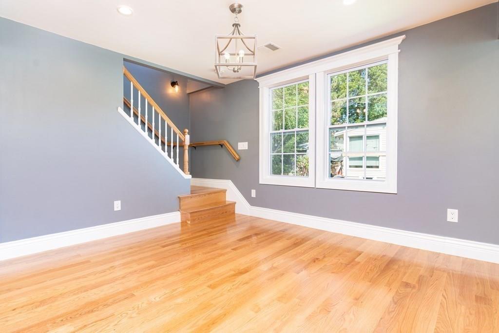23 Amelian Road Randolph, MA 02368 - Photo 27 of 39 a view of empty room with wooden floor and fan