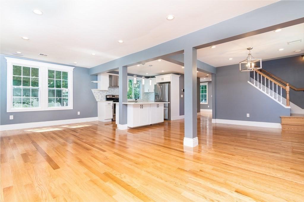 23 Amelian Road Randolph, MA 02368 - Photo 3 of 39 a view of an empty room with kitchen and window