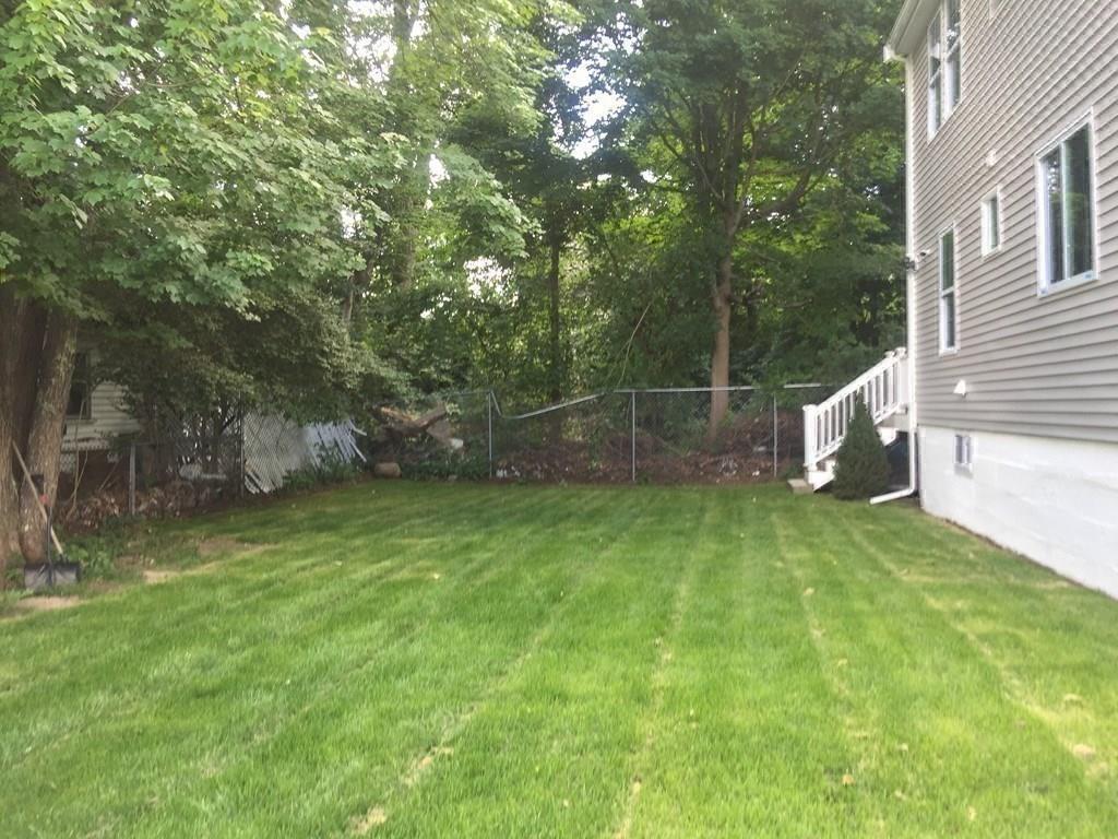 23 Amelian Road Randolph, MA 02368 - Photo 36 of 39 a backyard of a house with lots of green space