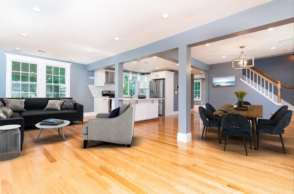 23 Amelian Road Randolph, MA 02368 - Photo 4 of 39 a living room with furniture and a dining table with wooden floor