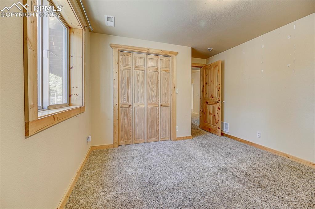 897 Fossil Creek Road Florissant, CO 80816 - Photo 14 of 40 an empty room with windows