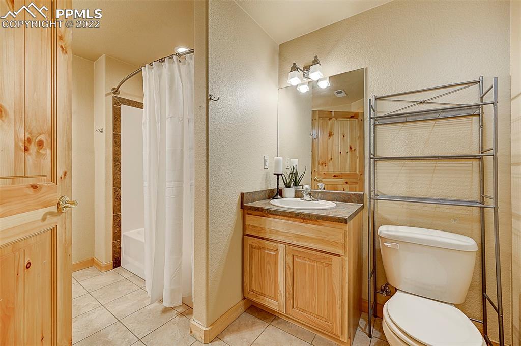 897 Fossil Creek Road Florissant, CO 80816 - Photo 17 of 40 a bathroom with a toilet sink and mirror