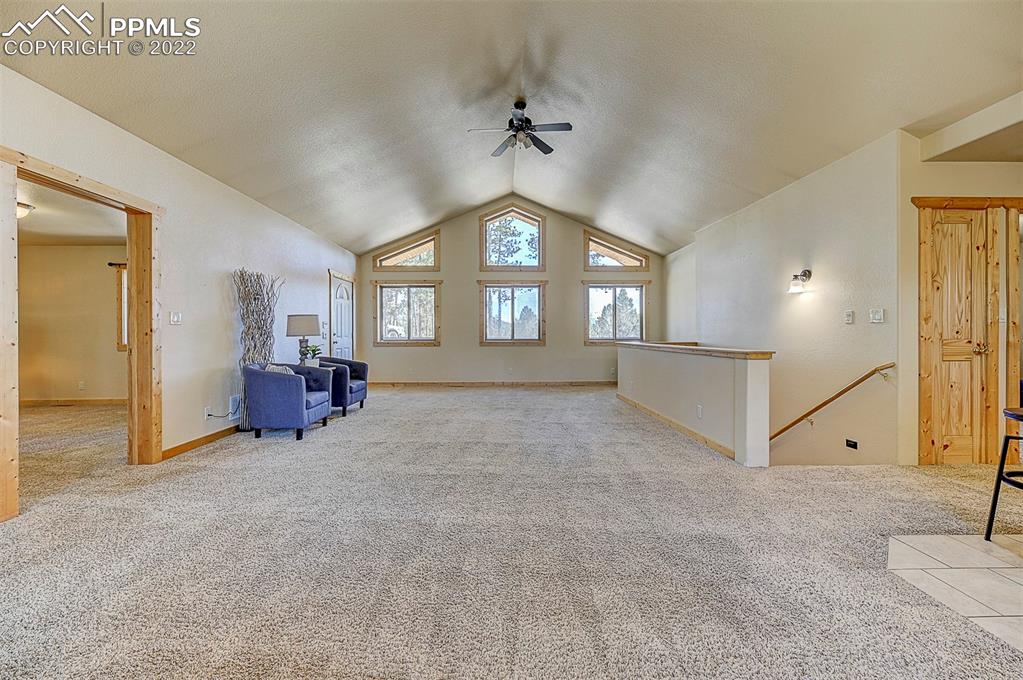 897 Fossil Creek Road Florissant, CO 80816 - Photo 5 of 40 wooden floor with chandelier and a large window