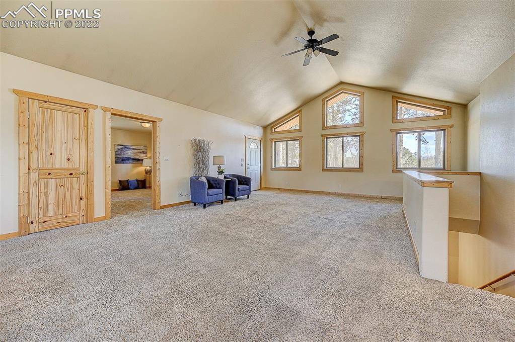 897 Fossil Creek Road Florissant, CO 80816 - Photo 7 of 40 an empty room with windows table and chair