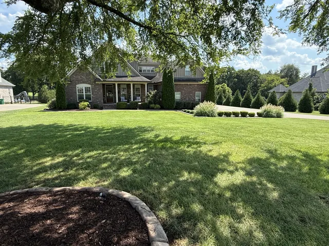 a front view of a house with a yard