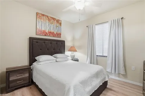 a bedroom with a bed and a painting on the wall