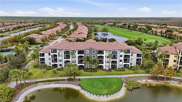 an aerial view of a house with a garden and lake view