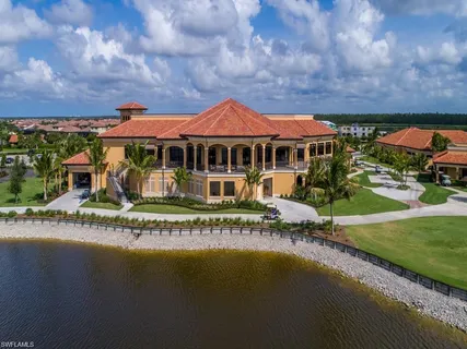 an aerial view of a house with a garden and lake view