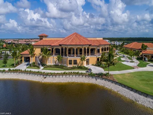 an aerial view of a house with a garden and lake view