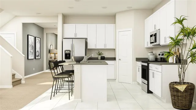 a kitchen with stainless steel appliances granite countertop a refrigerator and a stove top oven