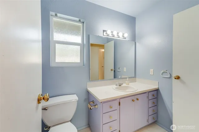 a bathroom with a toilet sink and mirror