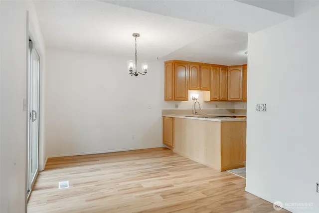 a kitchen with granite countertop a sink and a stove top oven