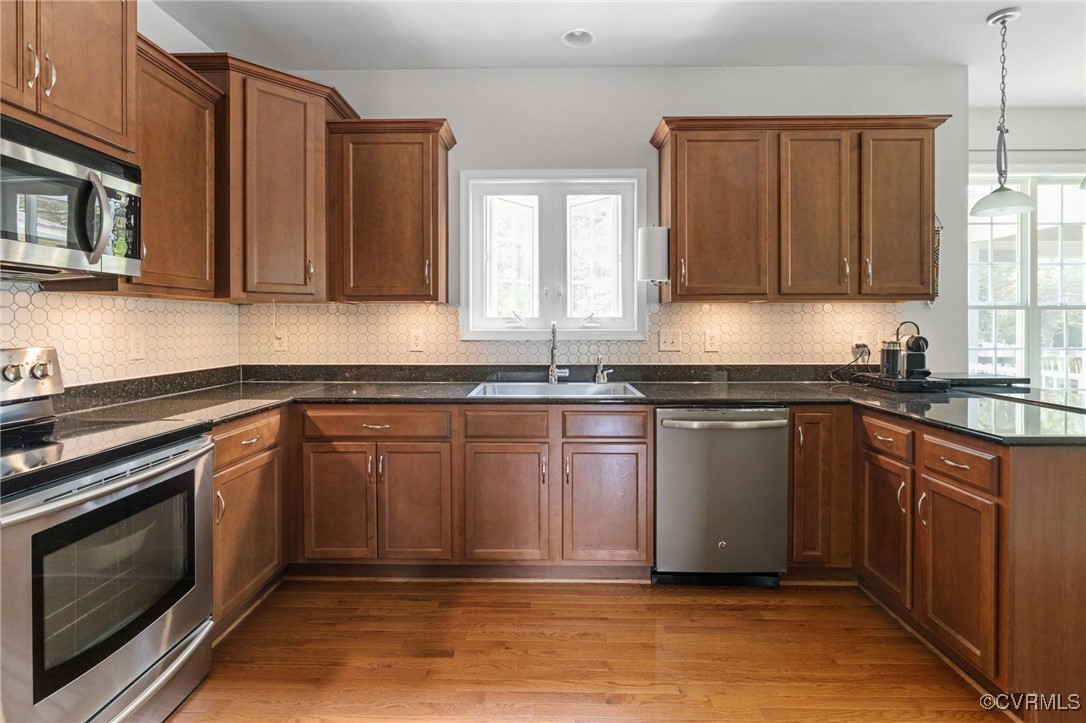 14300 Wallingham Loop Midlothian, VA 23114 - Photo 16 of 50 a kitchen with granite countertop a sink cabinets stainless steel appliances and a window