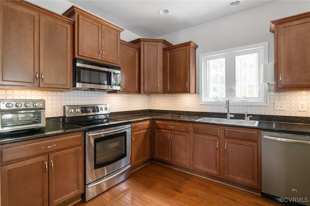 14300 Wallingham Loop Midlothian, VA 23114 - Photo 17 of 50 a kitchen with granite countertop cabinets stainless steel appliances a sink and window