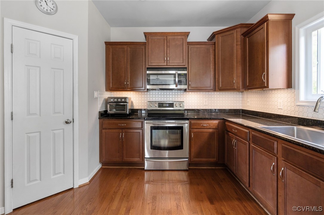 14300 Wallingham Loop Midlothian, VA 23114 - Photo 18 of 50 a kitchen with granite countertop wooden cabinets and stainless steel appliances
