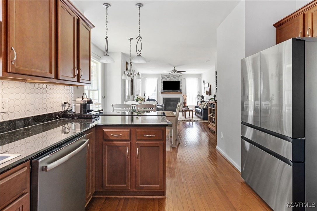 14300 Wallingham Loop Midlothian, VA 23114 - Photo 19 of 50 a kitchen with stainless steel appliances a refrigerator sink and wooden floor